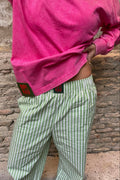 Sunrise Pants de Bipikau: pantalón ancho de rayas verdes y blancas, 100% algodón, con la Hibiscus Tee fucsia